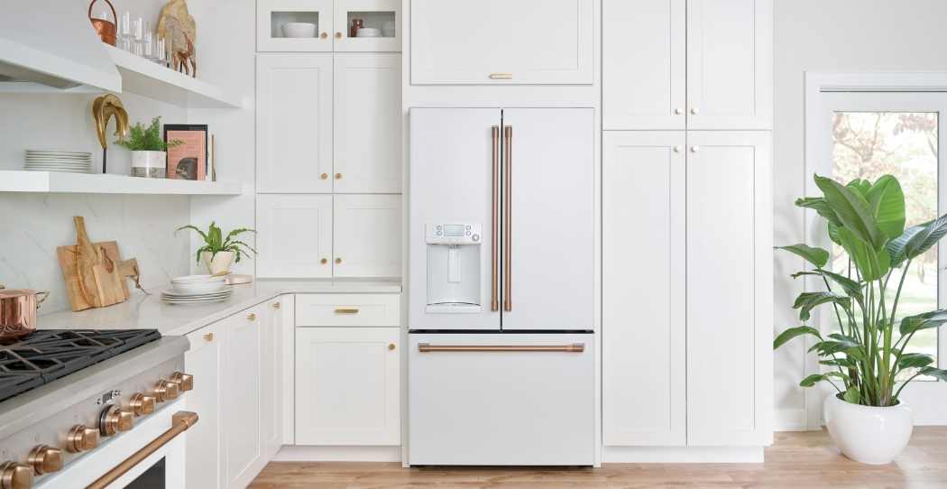 white refrigerator with brass handles and white cabinets